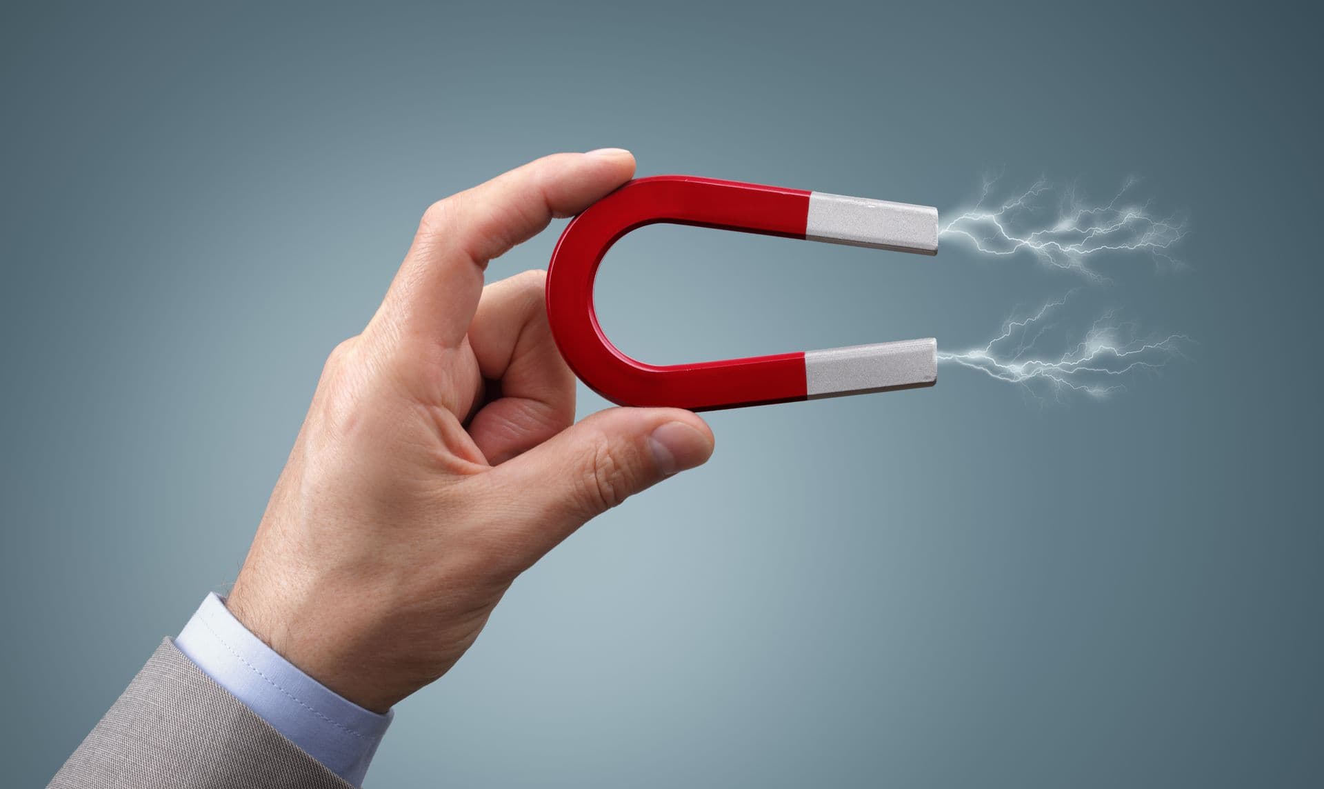 bigstock-Holding-a-horseshoe-magnet-aga-79293463.jpg